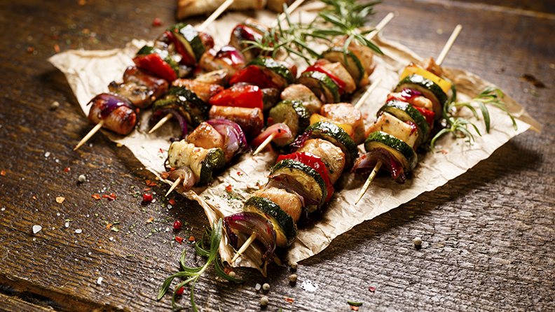 Grilled skewers with chicken meat, sausages, zucchini, peppers, onions and mushrooms