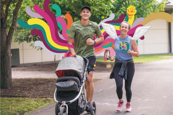 Woman holding her child in front of an aeroplane