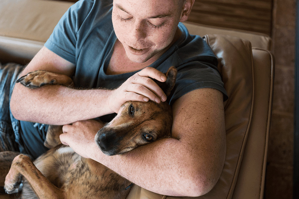 Man patting his dog