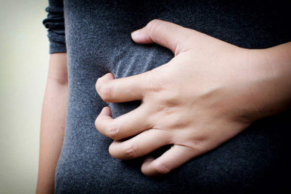 Person holding their stomach