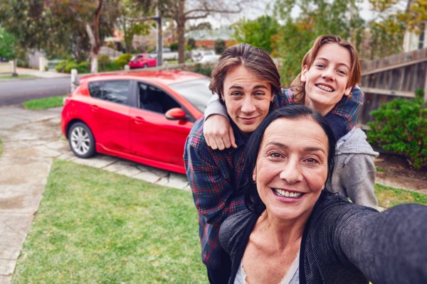 Mother and two sons smiling for a selfie