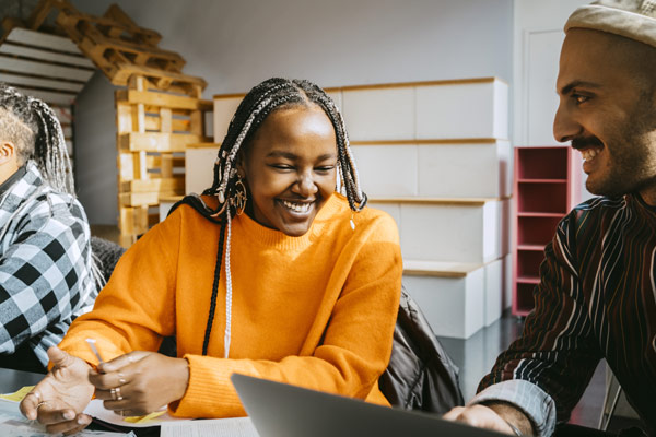 Woman sharing laptop in classroom